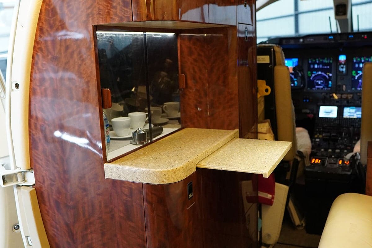 Interior view of the aircraft cabin with two seats and a table.