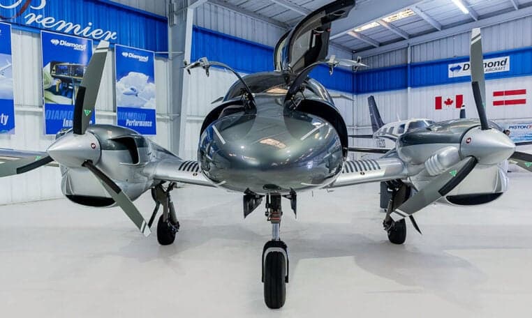 Front view of a Diamond DA62 with its gull-wing doors open.