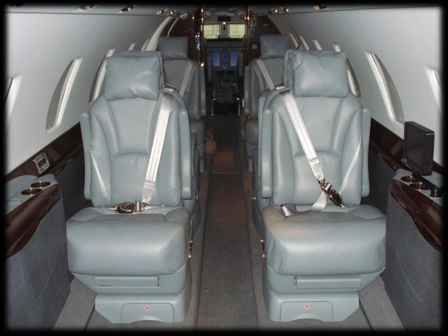 View down the center aisle of the aircraft cabin.