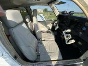 Interior view of the aircraft showing the front seats and instrument panel.