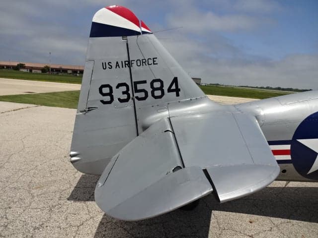 Close-up of the tail of the silver T-6 Texan aircraft showing the US Air Force marking and tail number.