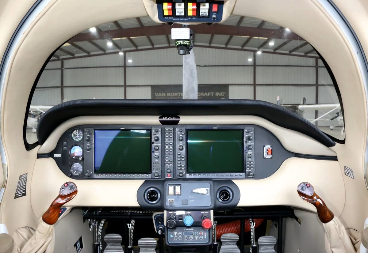 The cockpit of a Columbia 350 aircraft featuring dual display screens and controls.