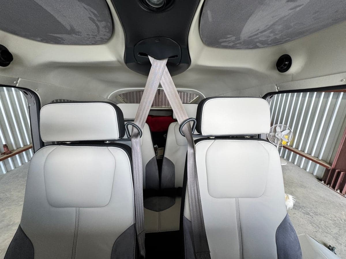 Rear seats of the aircraft, showing the headrests and seatbelts.