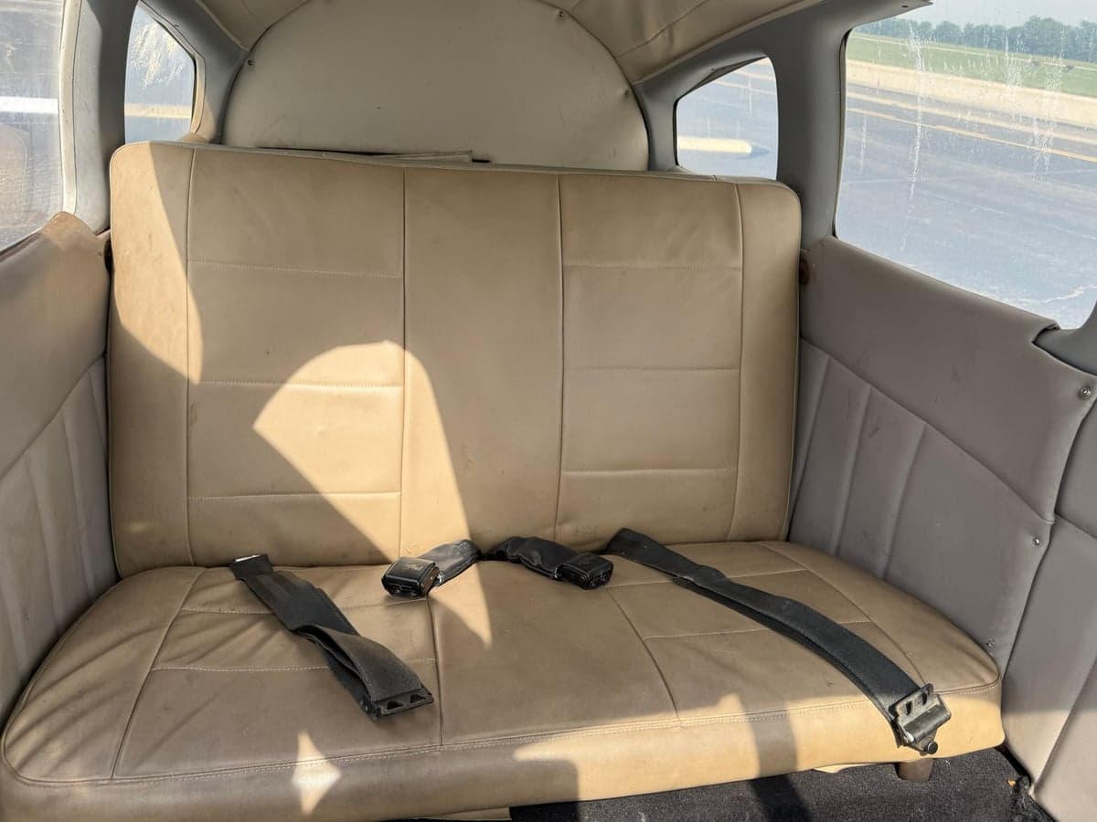 Rear bench seat with seatbelts in the cabin of the aircraft.