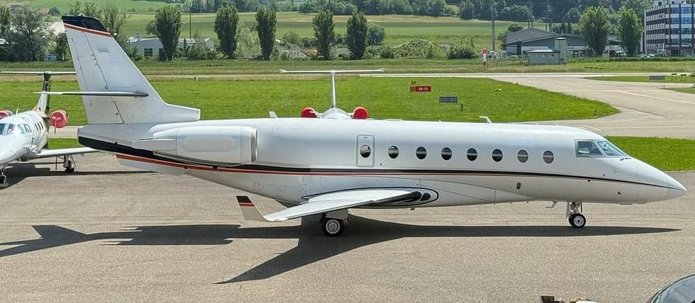 A Gulfstream G280 business jet is parked on the tarmac.