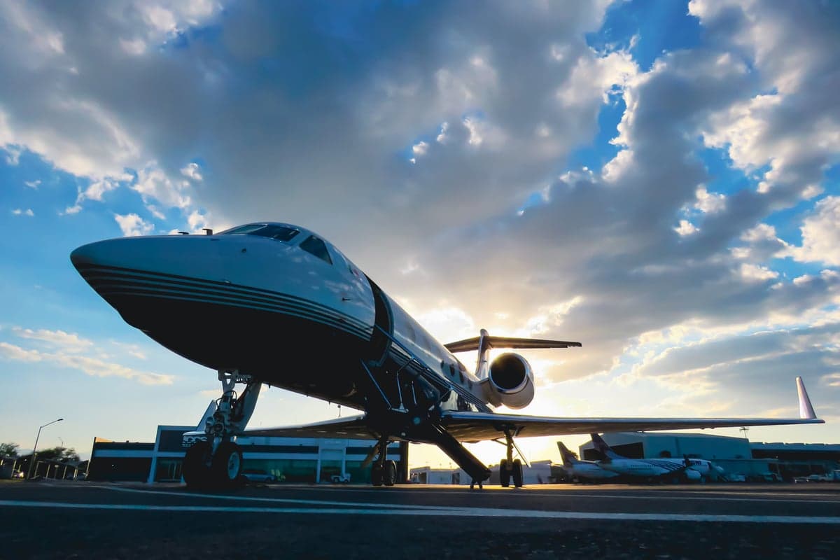 XA-OVA aircraft parked on the tarmac at sunset.