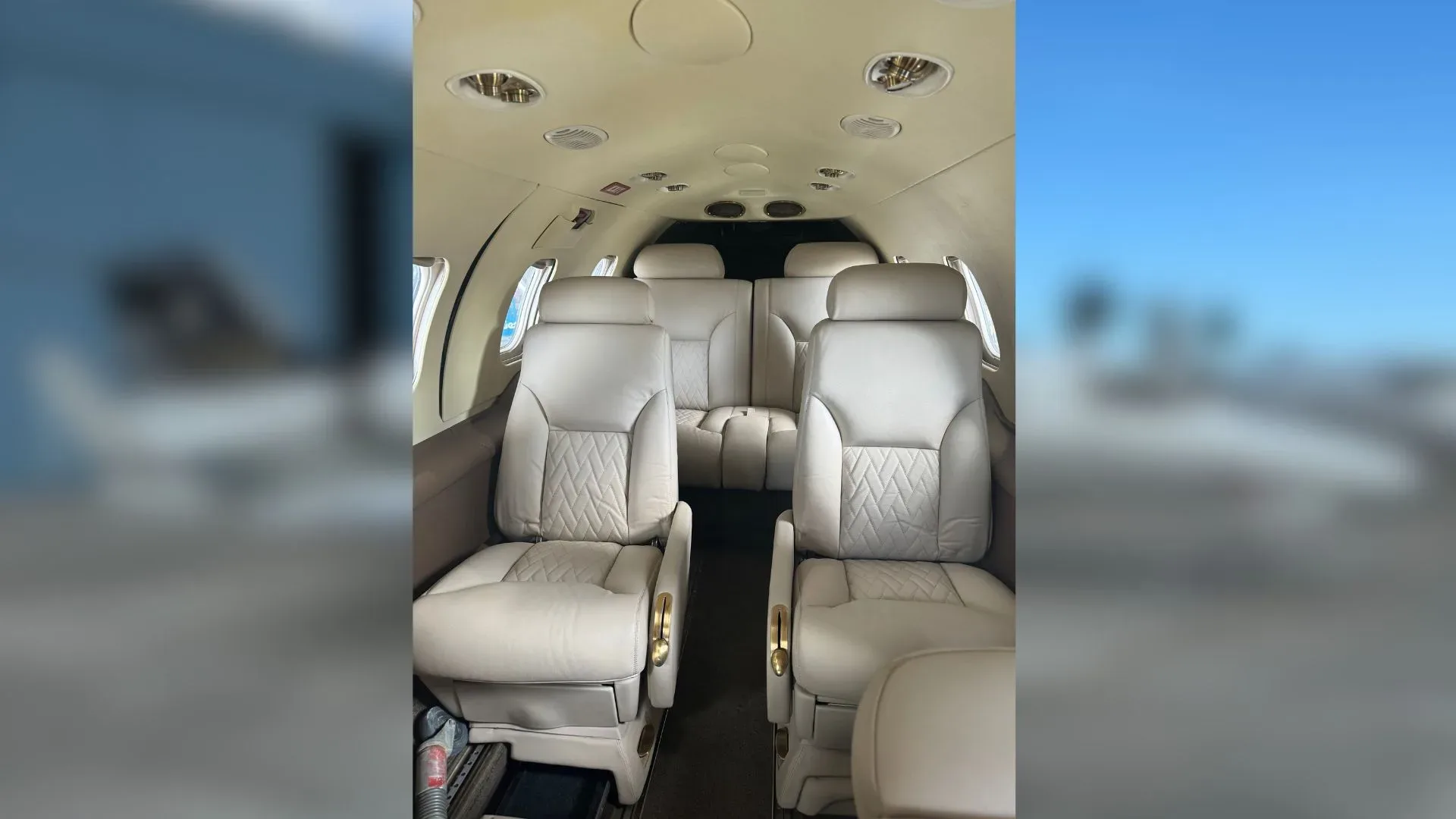 View of the Learjet 35A cabin with light-colored leather seats.