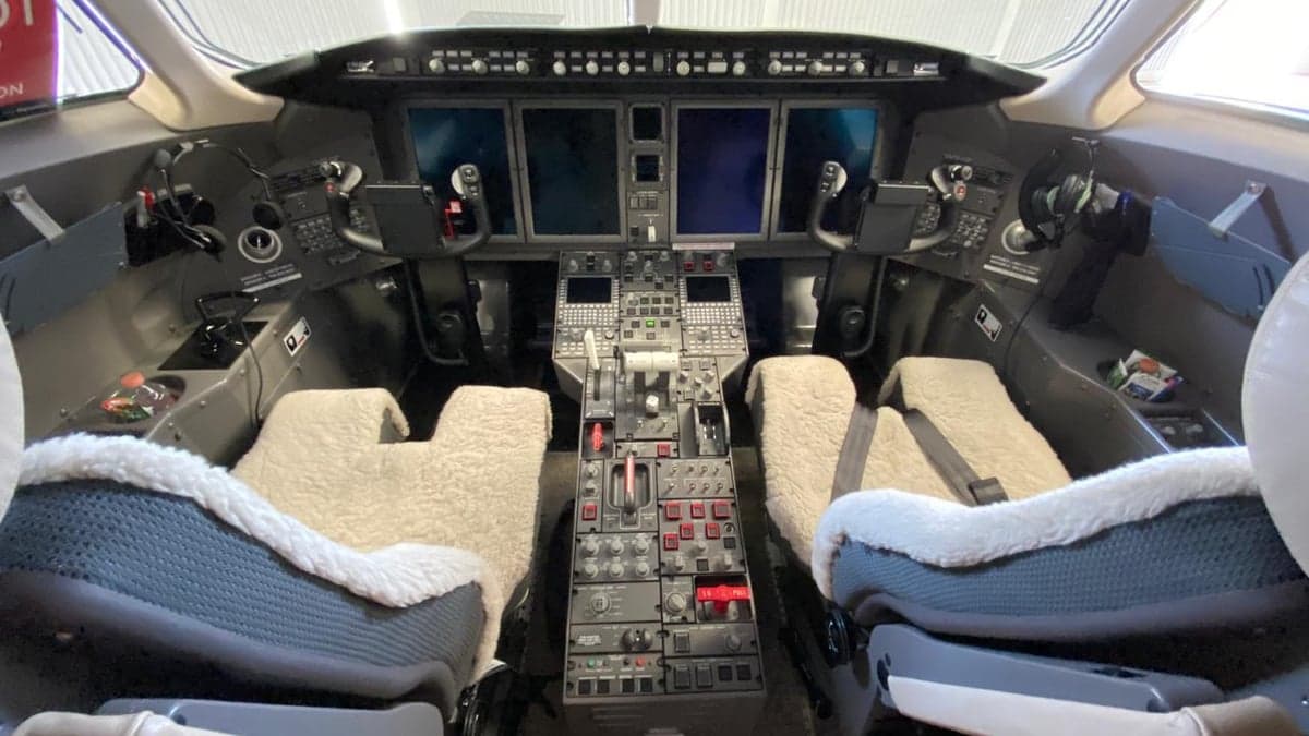 View of the aircraft cockpit with instrument panel and seats.