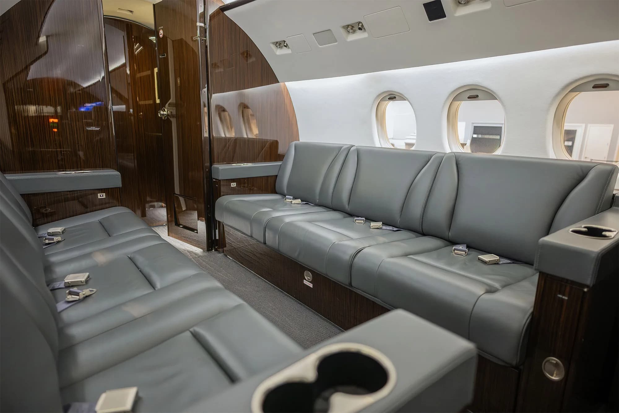 View of the aircraft interior with a gray leather couch.