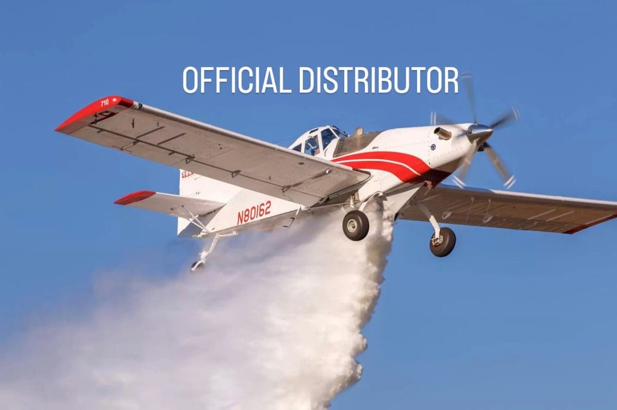 An Air Tractor crop duster sprays a field.