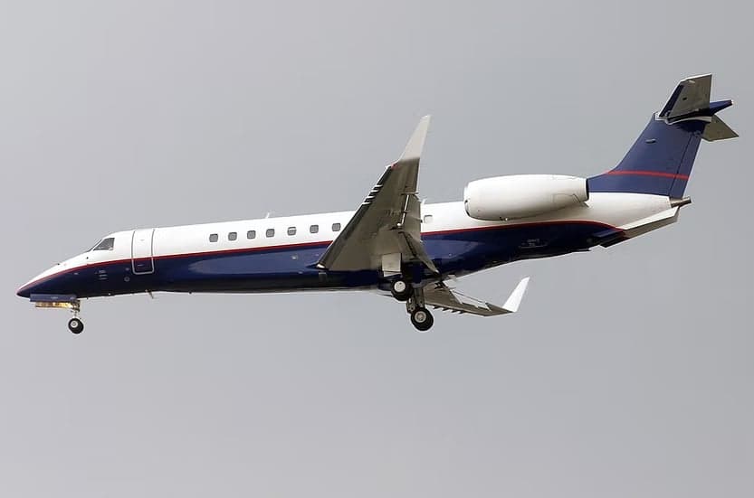 Embraer Legacy 650 in flight with landing gear down.