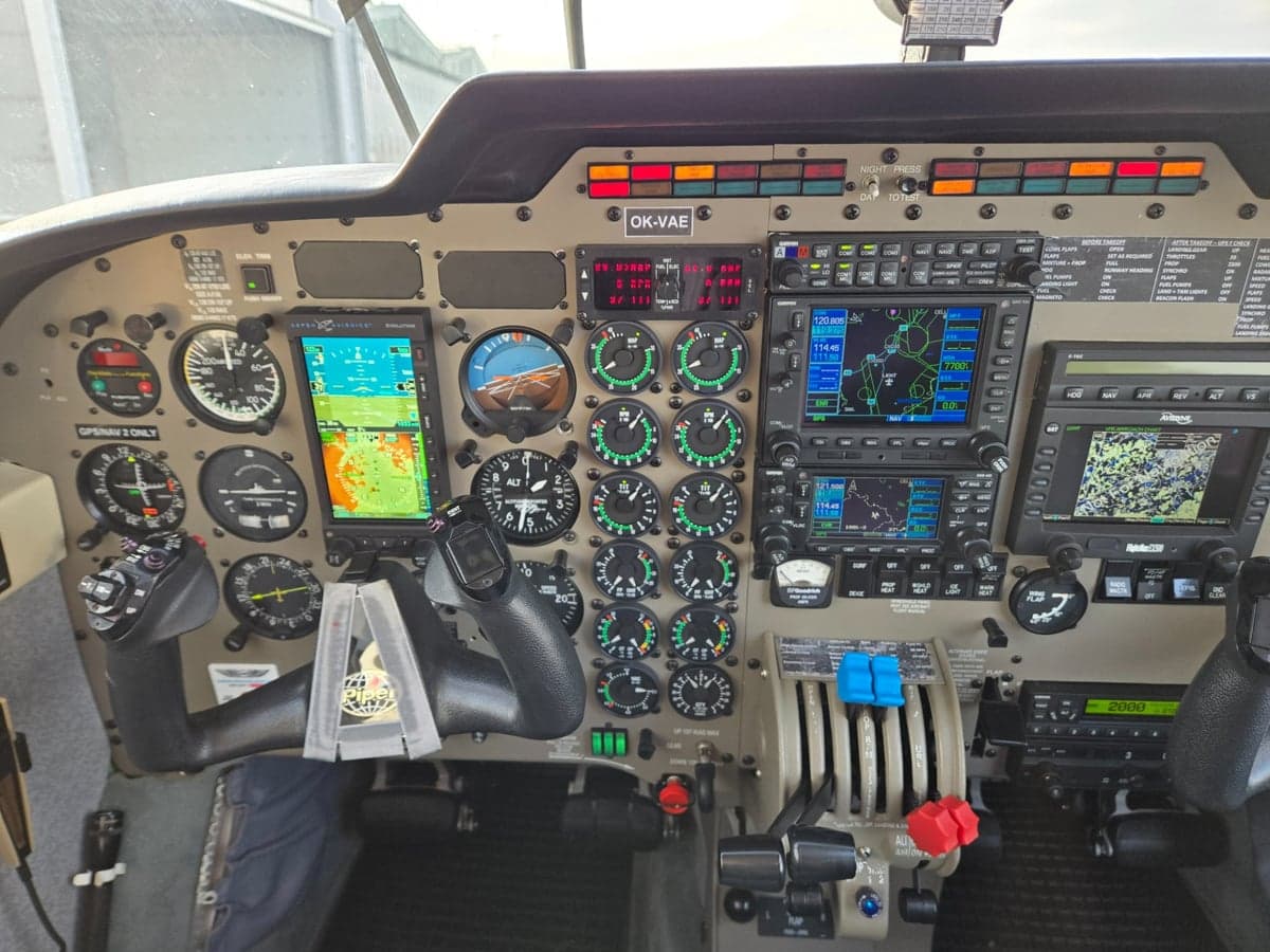 The cockpit features a full instrument panel with modern avionics and controls.