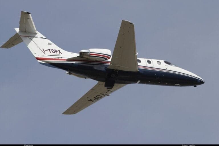 Eclipse 500 in flight with blue sky background.