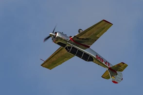 LY-EUG aircraft in flight from a head-on view.