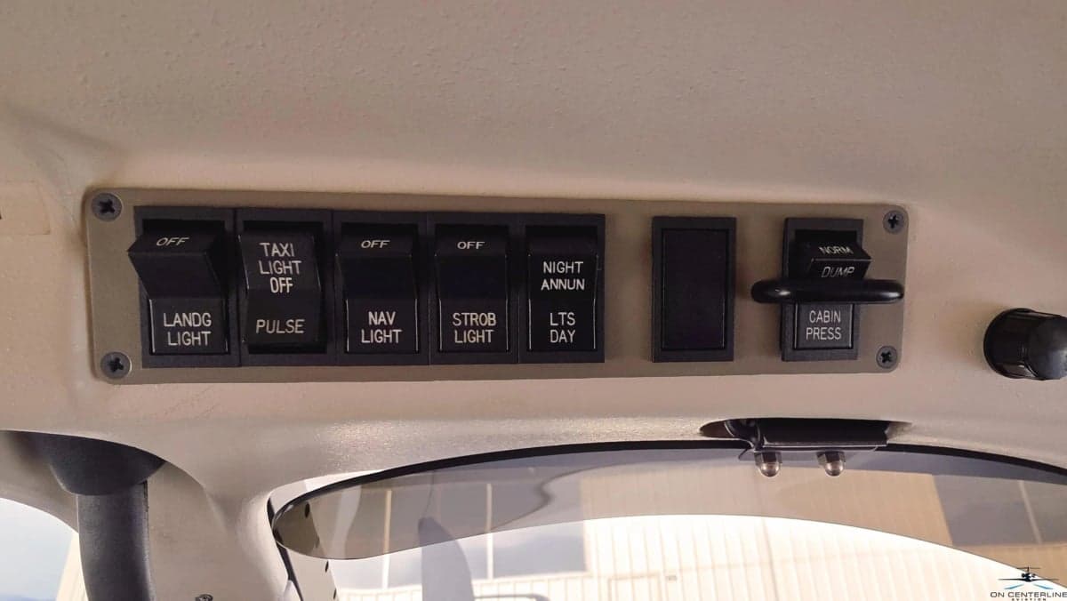 Light switches and cabin pressure controls in the cockpit.
