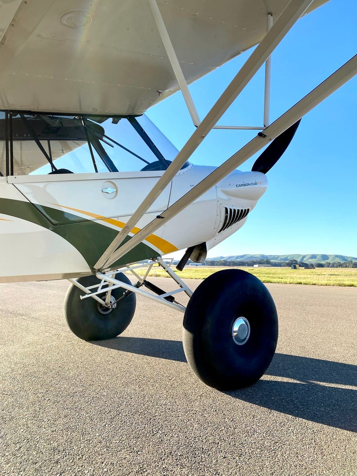 Close up of the front of a Carbon Cub FX-3 aircraft on the tarmac.