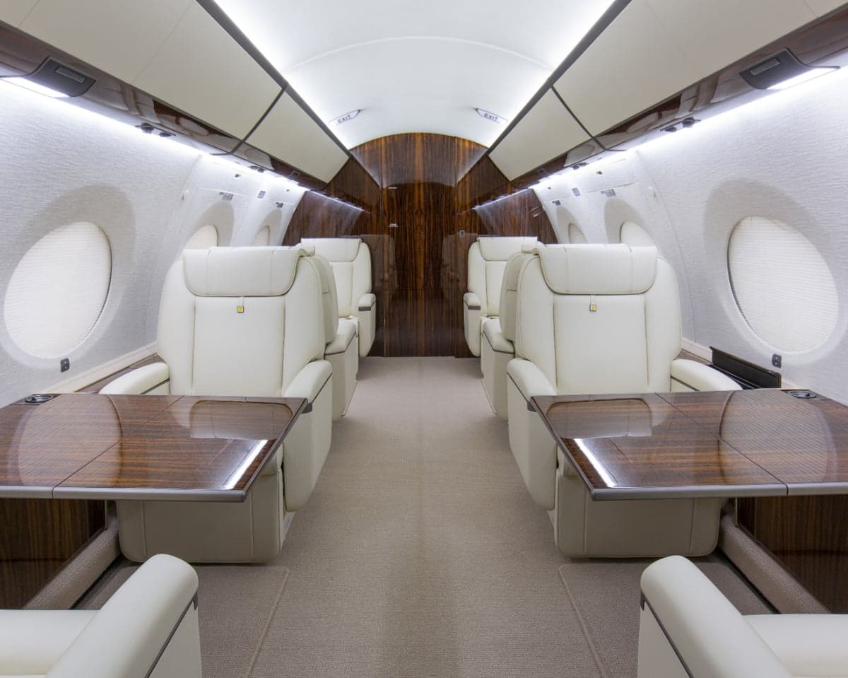 A view of the aircraft's interior with seats and tables.