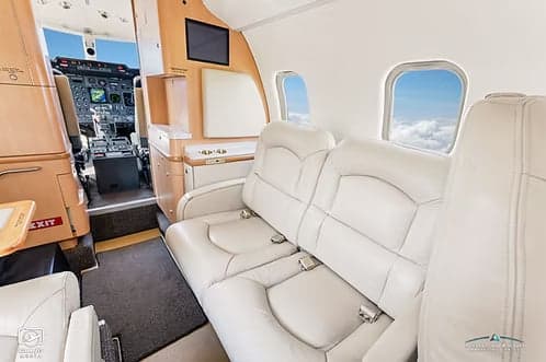 The interior of a Learjet 45XR with white leather seats.