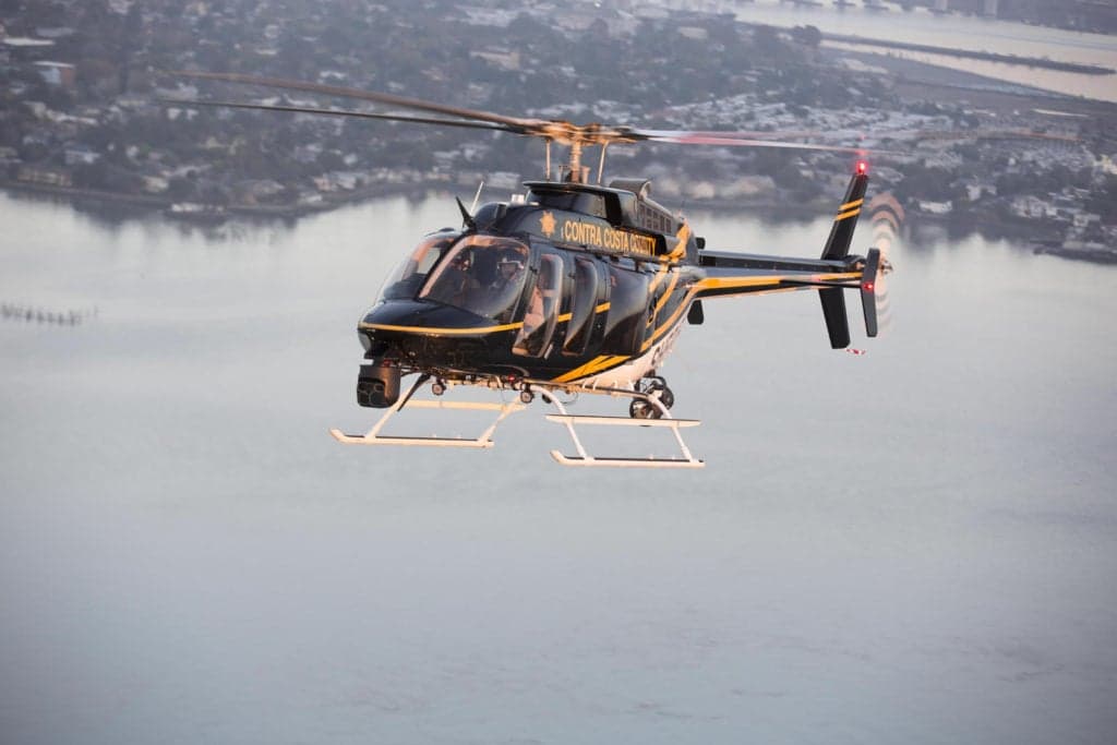 Contra Costa County Sheriff helicopter in flight over water.