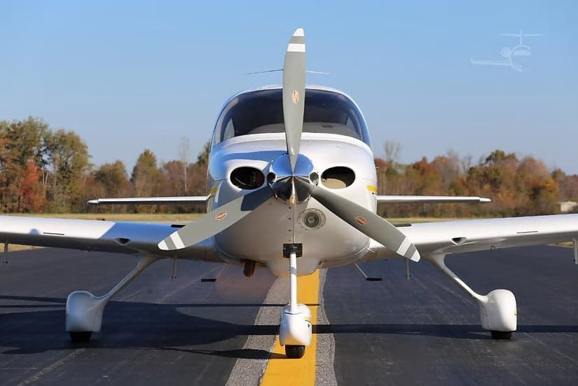 Front view of a Cirrus SR22 aircraft with its propeller visible.