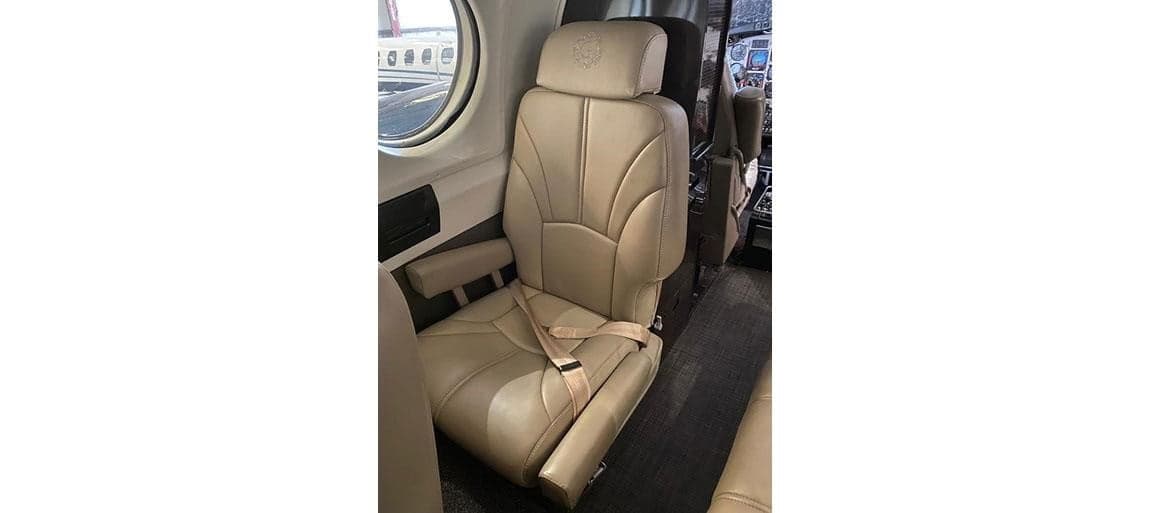Interior view of a tan leather seat inside the aircraft cabin.