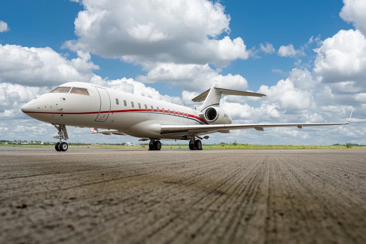 A Bombardier Global Express aircraft with registration N104AD parked on the tarmac.