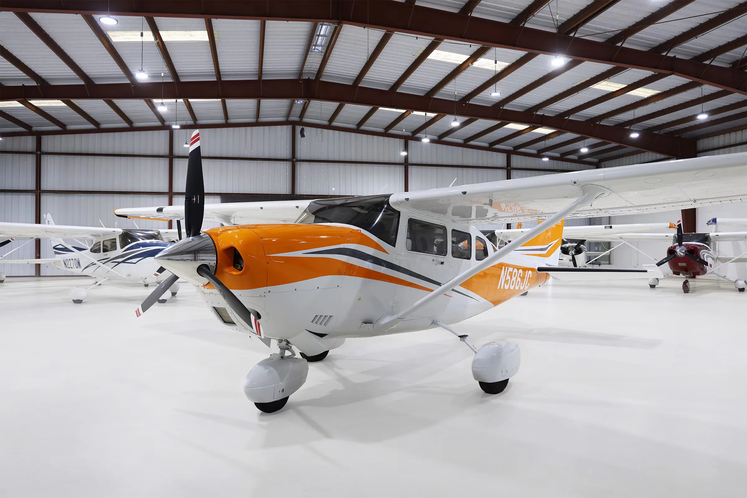 N586JC Cessna Stationair T206H in a hangar, front quarter view.