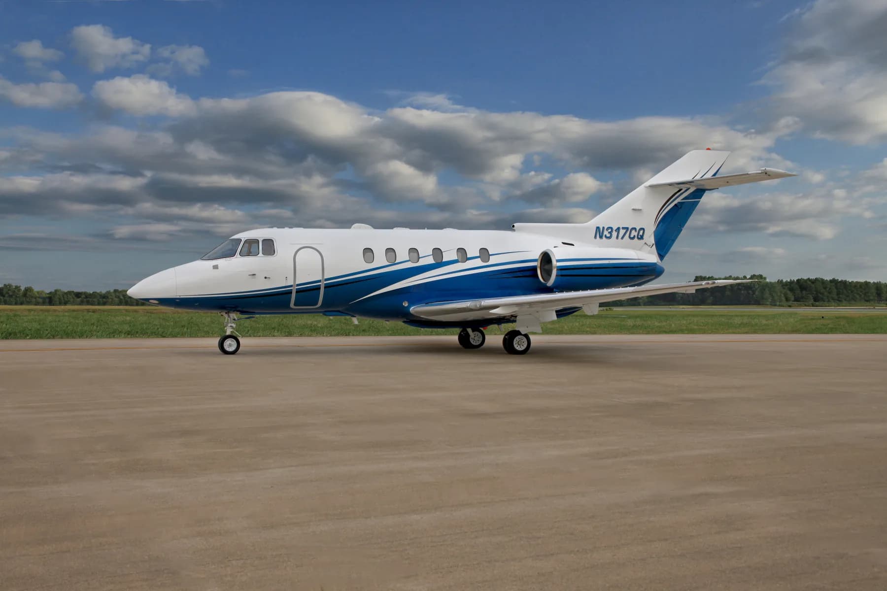 Side view of the N317CQ aircraft on the tarmac with a blue and white paint scheme.