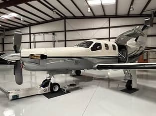 Side view of a turboprop aircraft in a hangar.