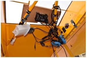 Interior view of the yellow Piper Cub showing seats and controls.