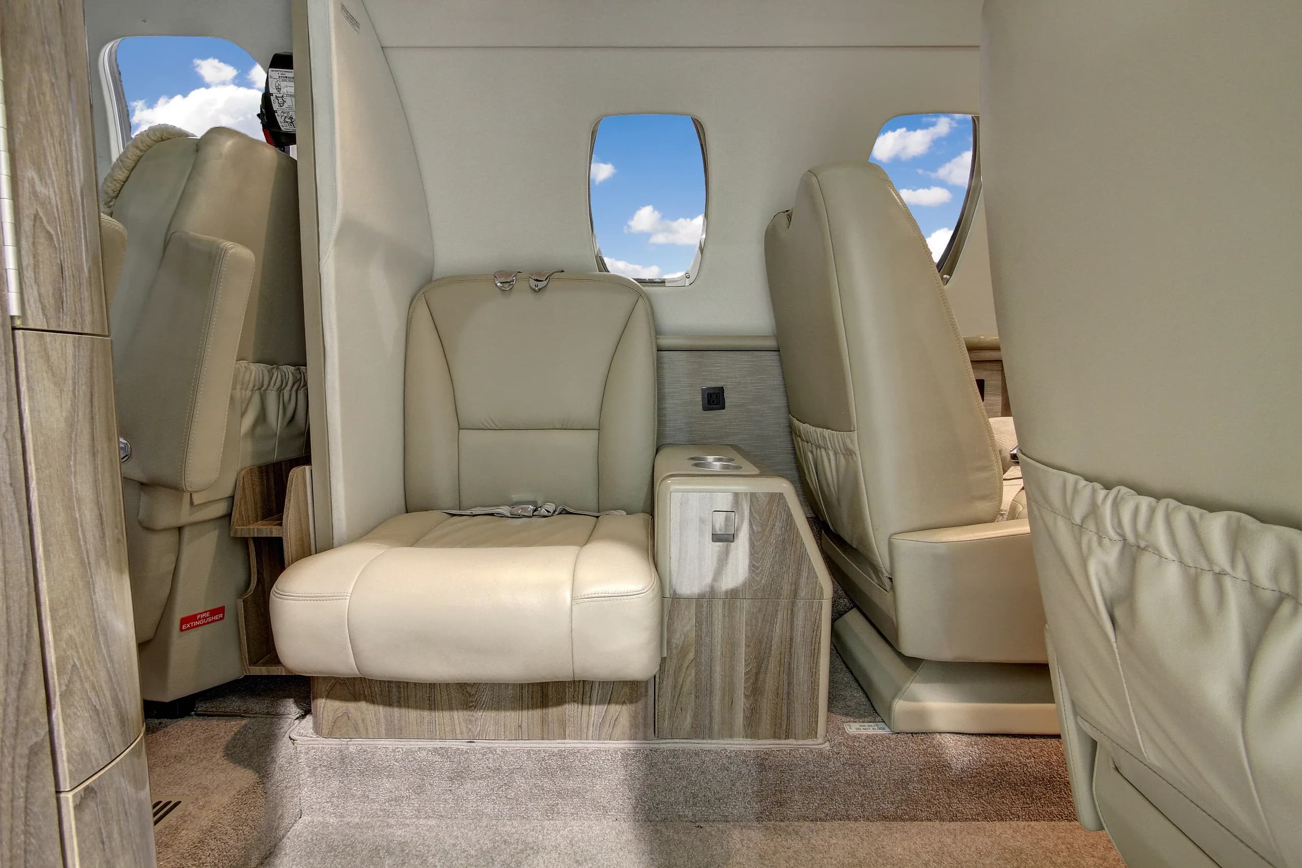 The interior of a Cessna Citation CJ3 features leather seats and wood trim.