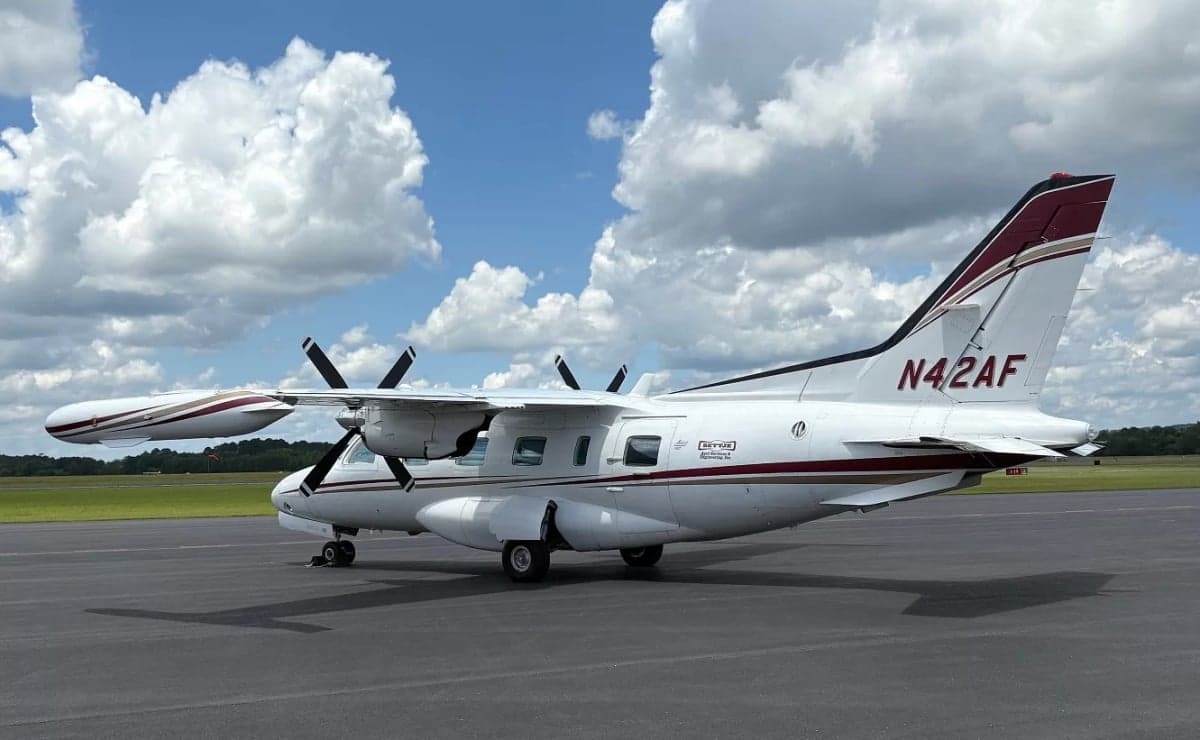 Rear side view of the aircraft N42AF on the tarmac.