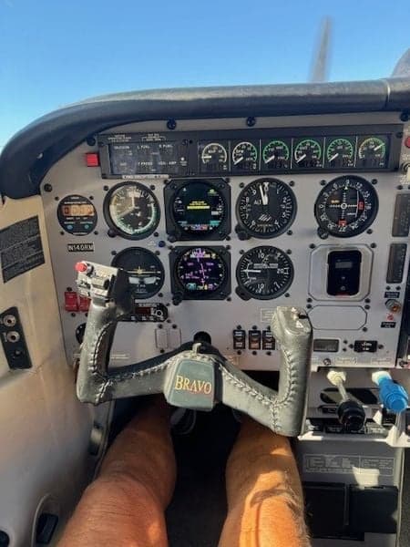 Close-up of the aircraft's instrument panel and yoke with 'Bravo' on it.