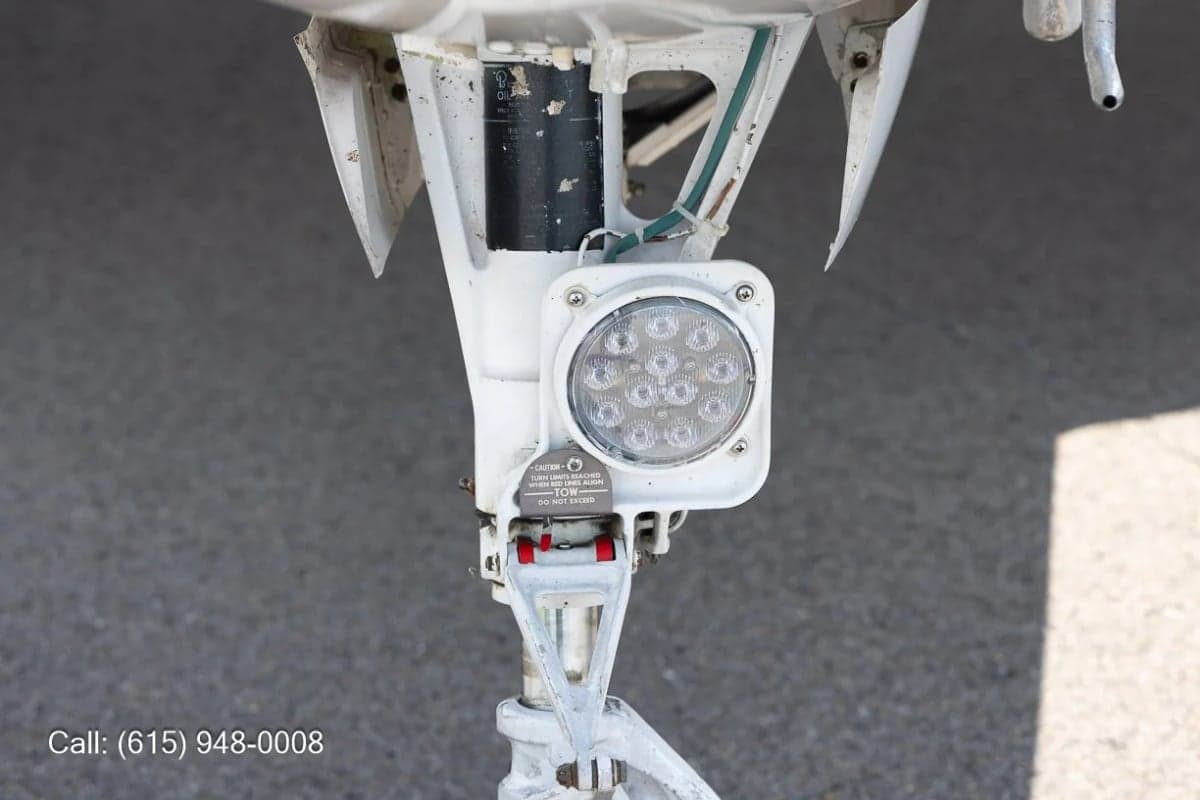 Close up of the nose landing gear and light of a Beechcraft Baron.