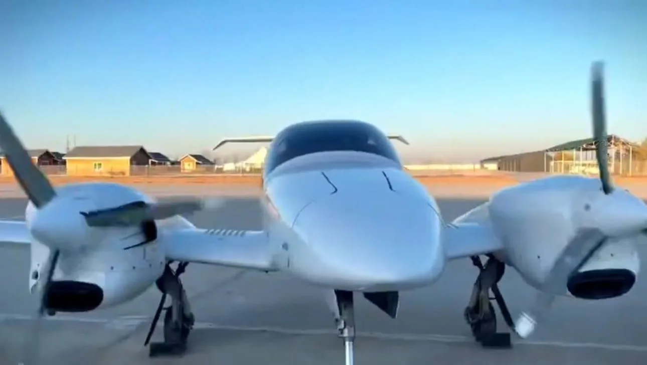 Front view of a Diamond DA42 aircraft on the tarmac.