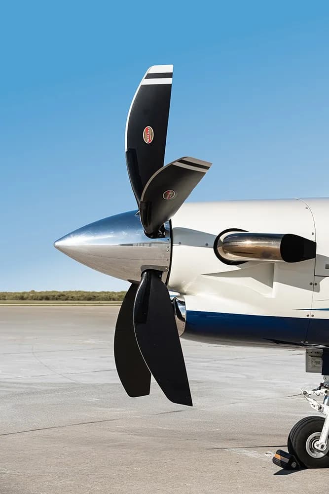A close-up view of the three-bladed propeller and engine cowling of the TBM 930 aircraft.