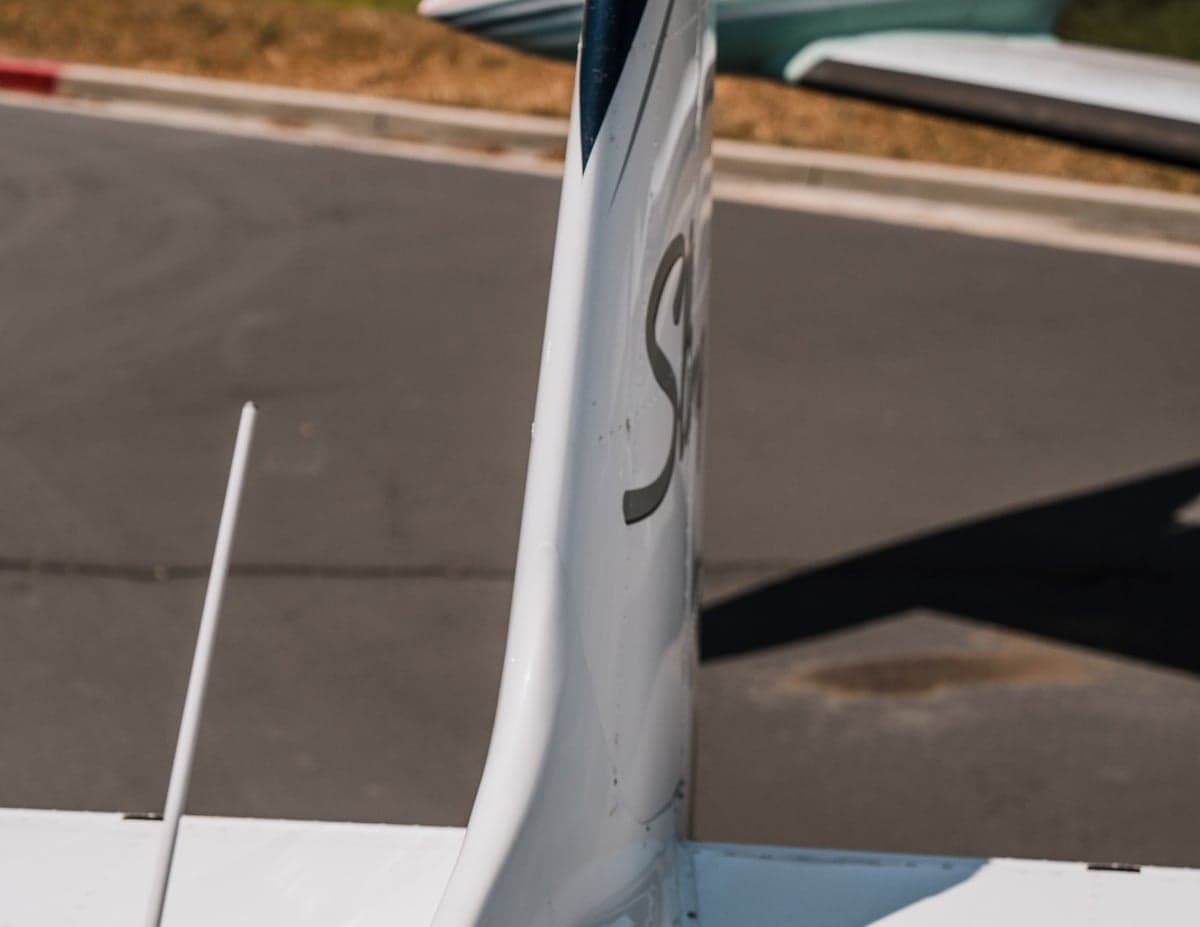Close up of the tail of the Sling LSA aircraft, showing the Sling logo.