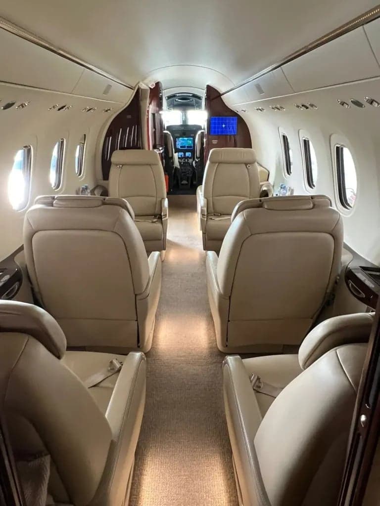 A view down the aisle of the aircraft cabin towards the cockpit.