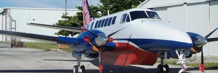 A blue and white turboprop aircraft on the ground.