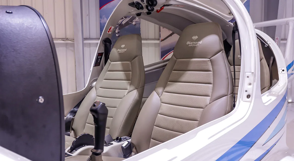 A close-up view of the tan leather seats inside the cabin of a Diamond DA40 aircraft.