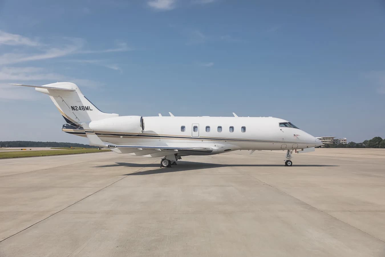 Side view of the Challenger 300 aircraft with registration N248ML on the tarmac.