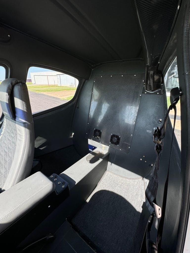 The interior of a Flight Design F2 aircraft, showing the seats and rear panel.