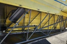 Yellow biplane in a hangar.