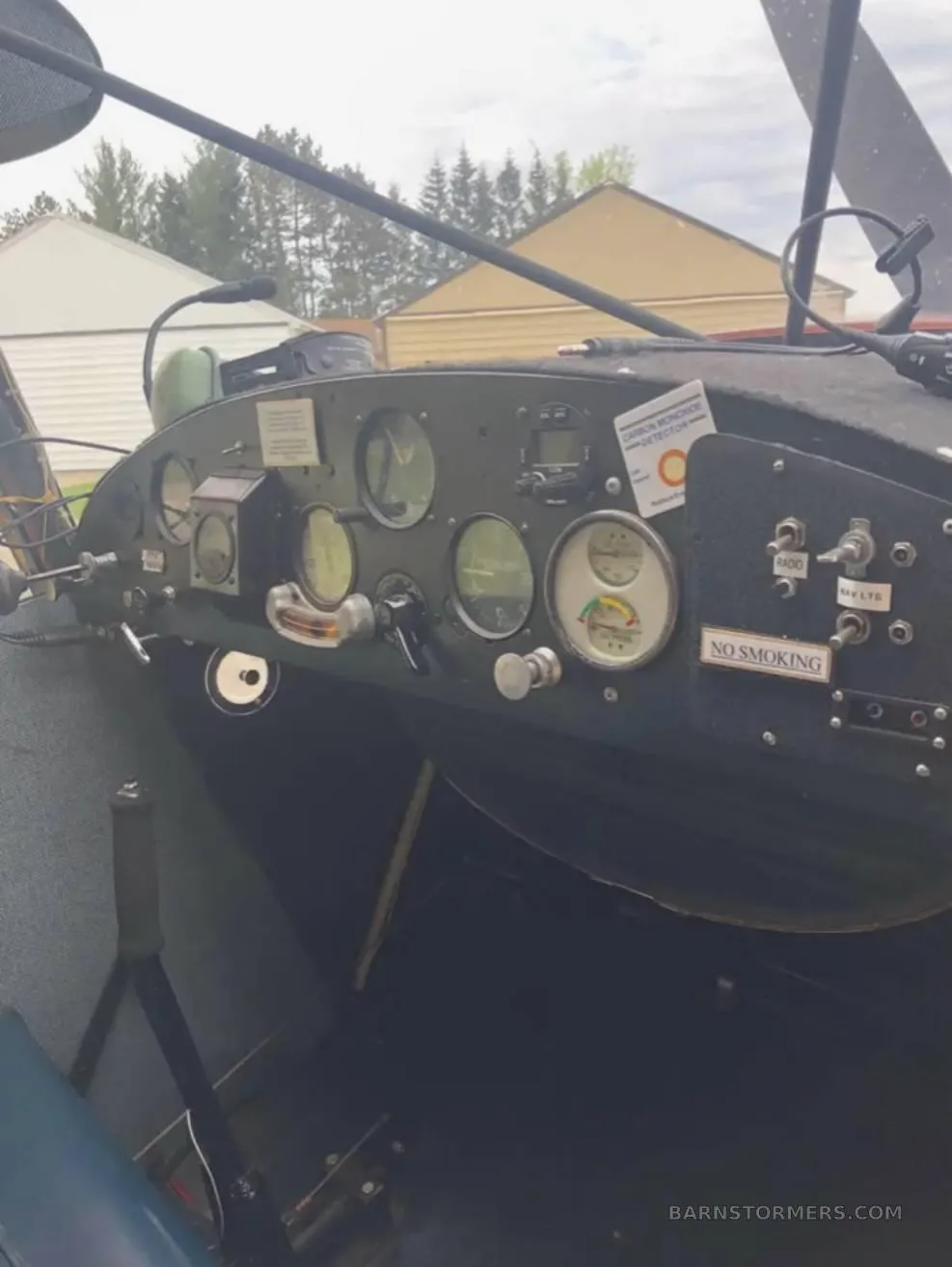 A close-up view of the instrument panel in an orange single-engine aircraft.