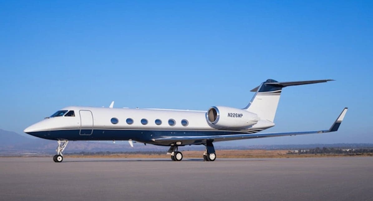 Gulfstream business jet with blue and white paint scheme on the tarmac.