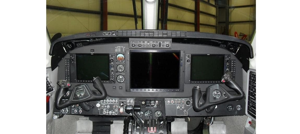 The cockpit of a Beechcraft King Air with modern avionics.