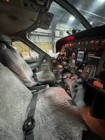 View of the cockpit with sheepskin seat covers and instrument panel.