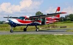 Cessna Caravan with a red, white, and blue paint scheme on the tarmac.