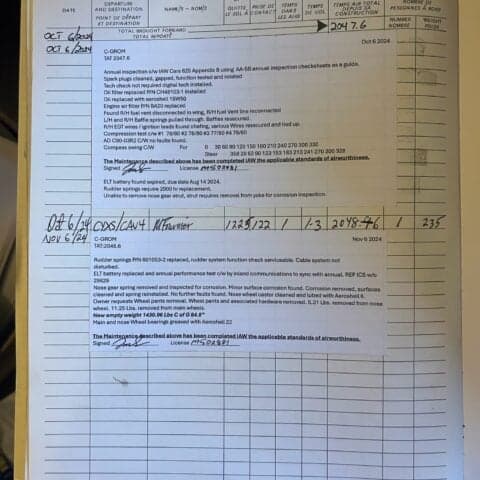A page from the aircraft's maintenance logbook with handwritten entries.