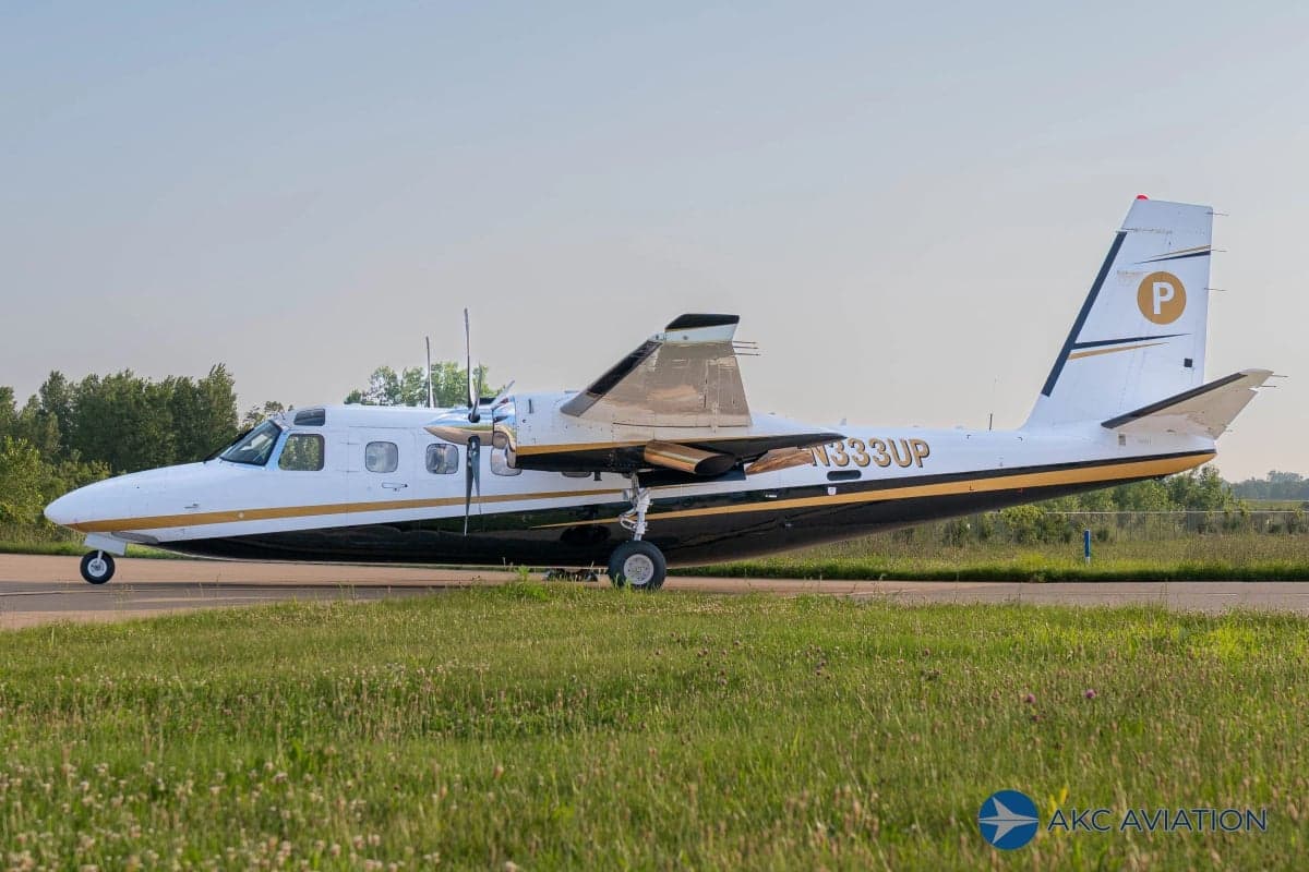 A Twin Commander aircraft with registration N333UP on the tarmac.